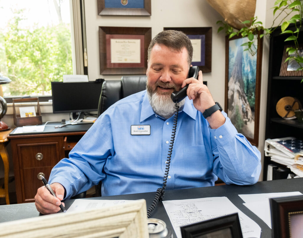 First Step CEO smiling on the phone